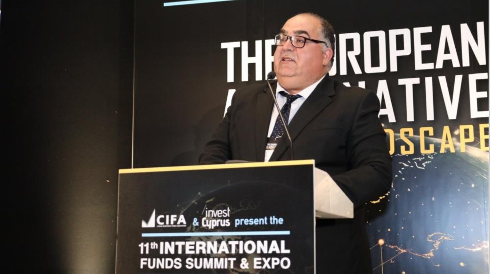 Marios Tannousis, CEO of Invest Cyprus, delivers a speech at a podium during the 11th International Funds Summit & Expo.
